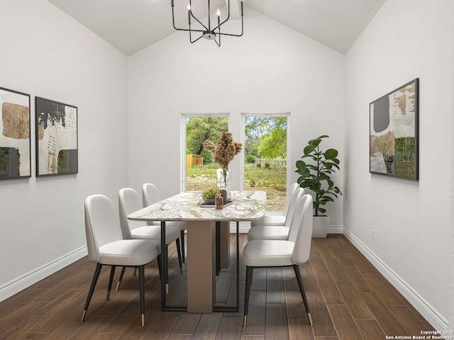 dining area featuring baseboards, dark wood finished floors, a chandelier, and high vaulted ceiling