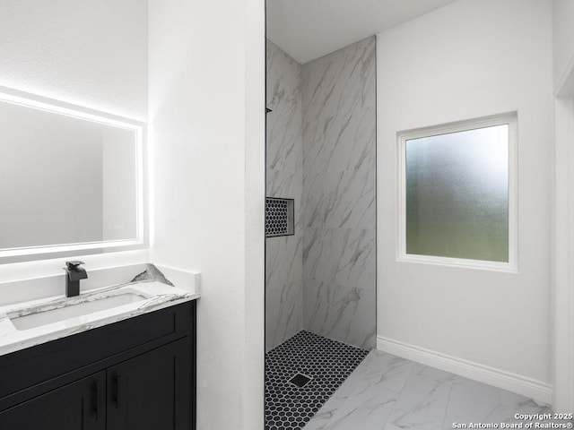 bathroom with vanity, a marble finish shower, and marble finish floor