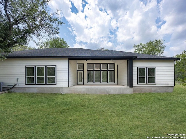back of house with a yard and a patio area