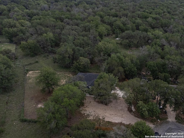 birds eye view of property with a wooded view
