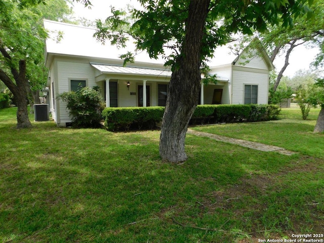 911 Austin, Sabinal, TX 78881 - view of front facade with central AC unit and a front lawn