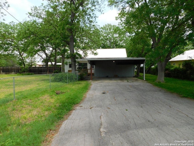 911 Austin, Sabinal, TX 78881 - exterior space with a carport, fence, a front yard, and aphalt driveway