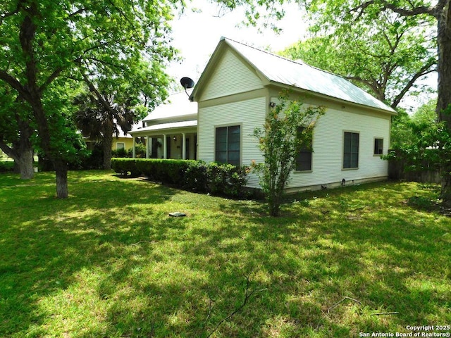 911 Austin, Sabinal, TX 78881 - view of home's exterior featuring metal roof and a lawn