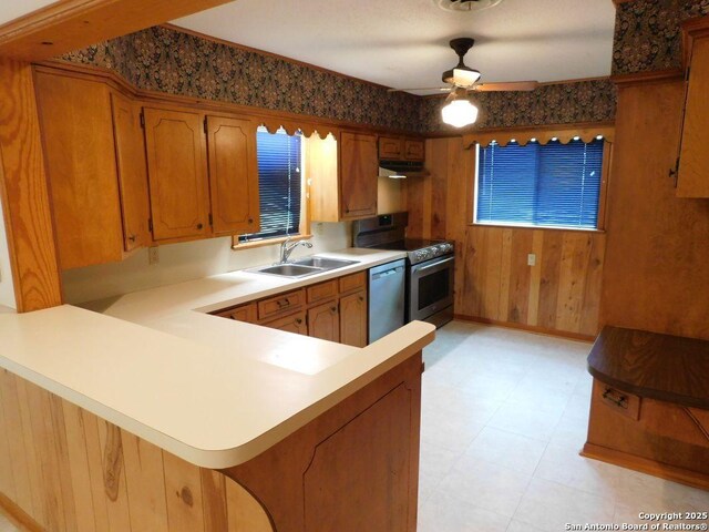 911 Austin, Sabinal, TX 78881 - kitchen with a sink, brown cabinets, under cabinet range hood, ceiling fan, and appliances with stainless steel finishes