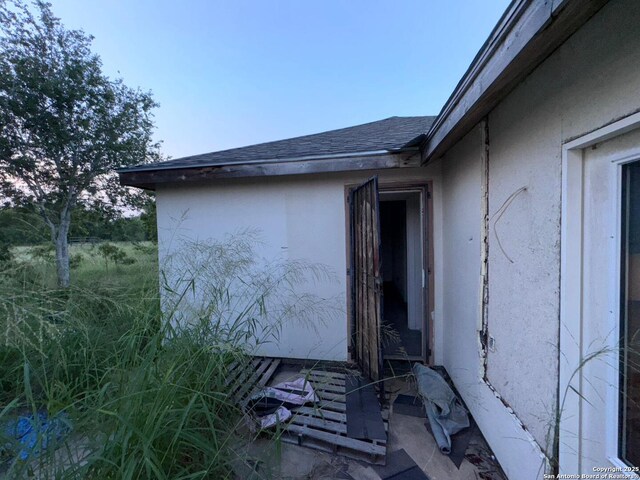 2424 S Victoria, Donna, TX 78537 - view of side of home featuring stucco siding and roof with shingles