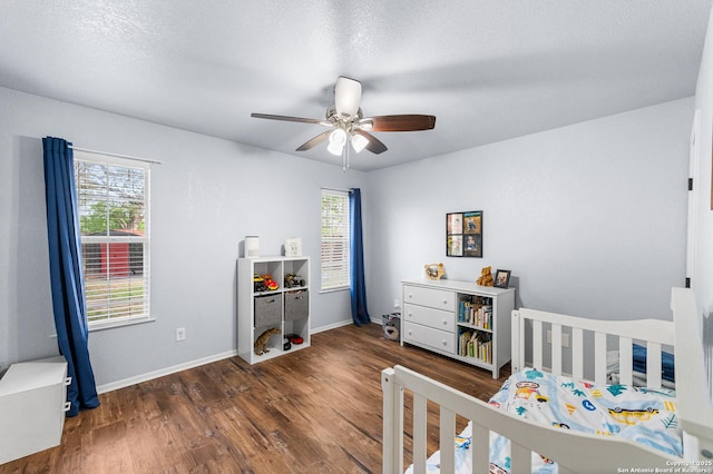 503 Lower Lacoste, Castroville, TX 78009 - bedroom featuring multiple windows, wood finished floors, and baseboards