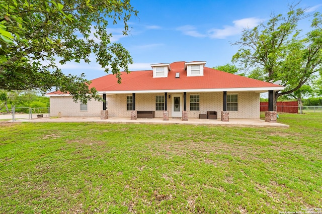 503 Lower Lacoste, Castroville, TX 78009 - country-style home featuring brick siding, a patio area, fence, and a front yard