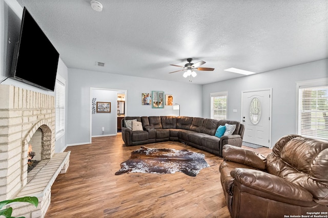 503 Lower Lacoste, Castroville, TX 78009 - living room with ceiling fan, a textured ceiling, visible vents, and wood finished floors