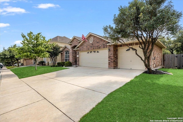 view of front of house featuring a front yard, brick siding, driveway, and a garage