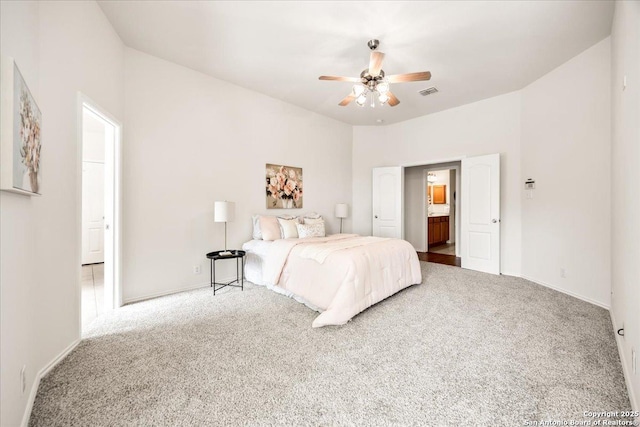 carpeted bedroom featuring visible vents, baseboards, and ceiling fan
