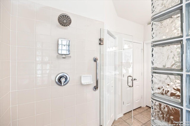 full bathroom with a stall shower and tile patterned floors