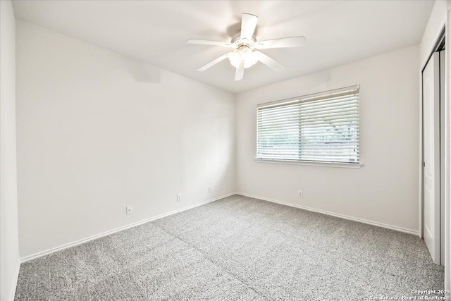 unfurnished bedroom featuring carpet flooring, a closet, baseboards, and ceiling fan