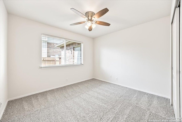 spare room with ceiling fan, carpet floors, and baseboards