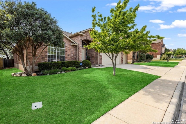 view of front facade with concrete driveway, brick siding, and a front lawn