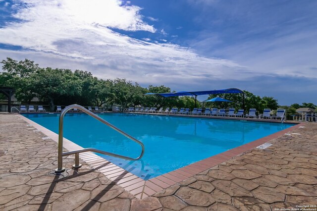 community pool with a patio area
