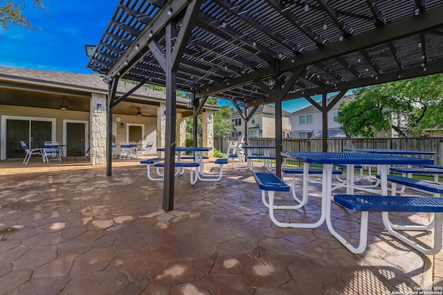 view of patio / terrace featuring a pergola, fence, a ceiling fan, and outdoor dining area