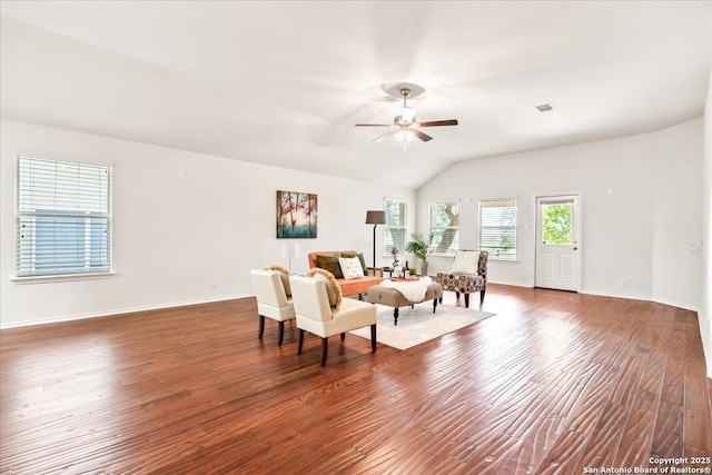 living area with vaulted ceiling, dark wood-style flooring, baseboards, and a ceiling fan