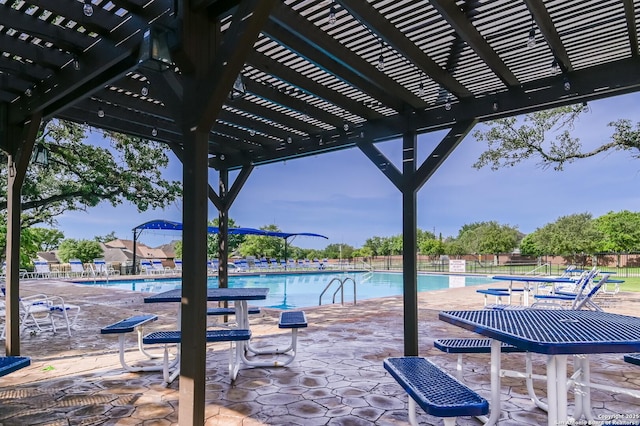 community pool featuring a pergola and fence