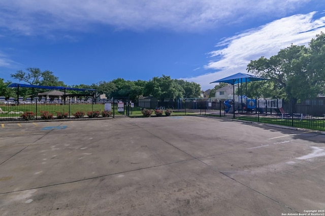 view of property's community featuring fence and uncovered parking