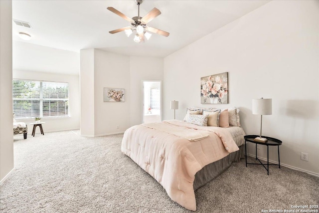carpeted bedroom featuring visible vents, baseboards, and ceiling fan