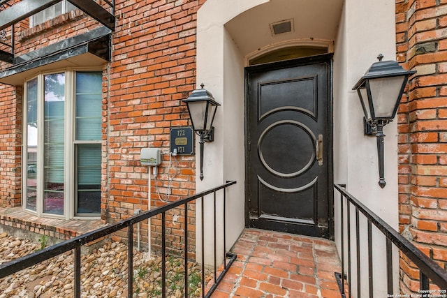7500 Callaghan Rd Unit 172, San Antonio, TX 78229 - doorway to property featuring brick siding and visible vents
