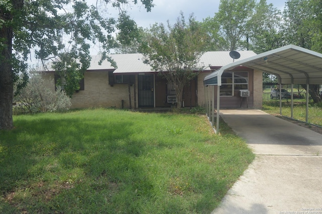 view of front of home with a detached carport, a front lawn, and driveway