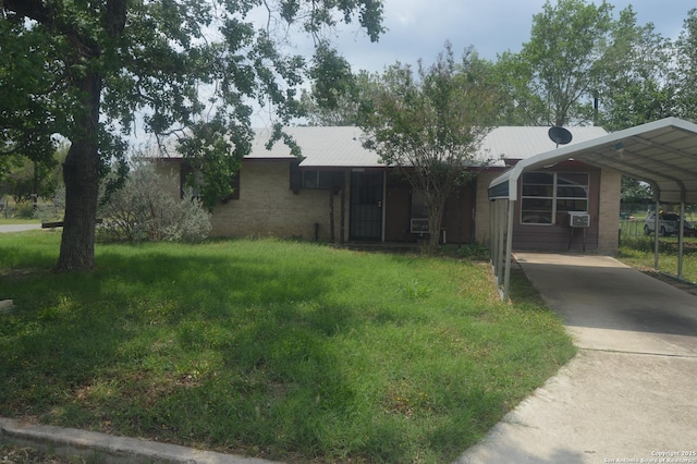 view of front of home with a front yard, cooling unit, driveway, and a carport