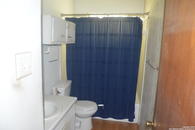 full bathroom with toilet, shower / tub combo with curtain, vanity, and wood finished floors