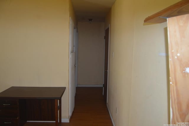 hall with wood finished floors and baseboards