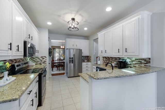 190 Da Vinci, San Antonio, TX 78258 - kitchen featuring appliances with stainless steel finishes, backsplash, a chandelier, a peninsula, and recessed lighting