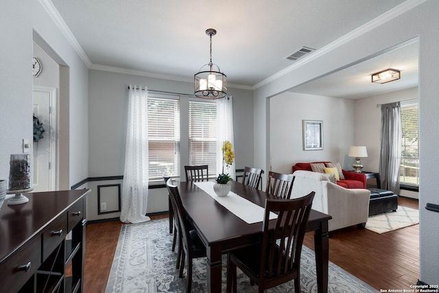190 Da Vinci, San Antonio, TX 78258 - dining space featuring dark wood-type flooring, crown molding, and a chandelier