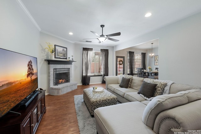 190 Da Vinci, San Antonio, TX 78258 - living area featuring a fireplace, recessed lighting, ceiling fan, crown molding, and dark wood-style floors