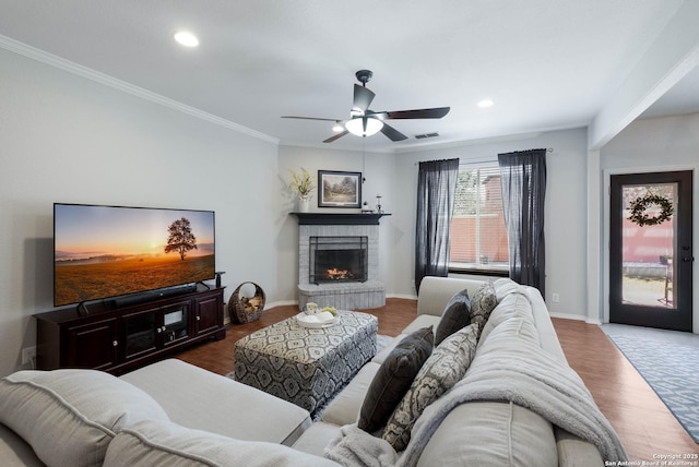 190 Da Vinci, San Antonio, TX 78258 - living room with a brick fireplace, ceiling fan, wood finished floors, ornamental molding, and recessed lighting