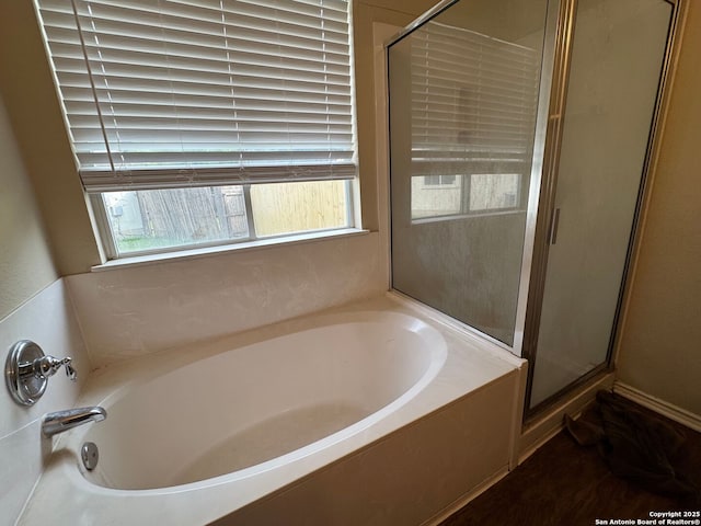 bathroom with a garden tub and a stall shower