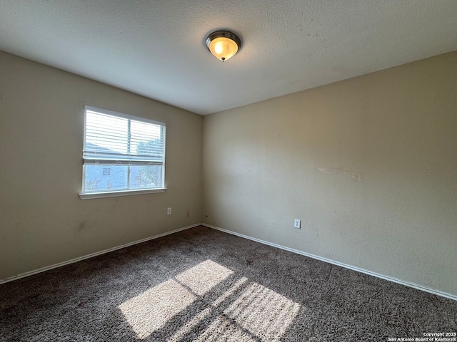 carpeted spare room with baseboards