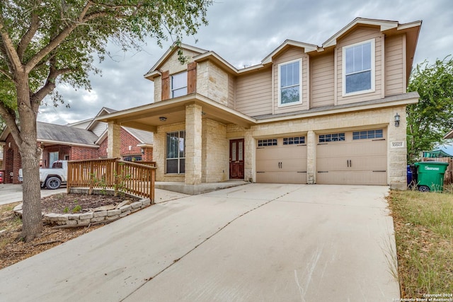 10603 Catfish Ln, San Antonio, TX 78224 - traditional-style home with an attached garage, stone siding, driveway, and covered porch