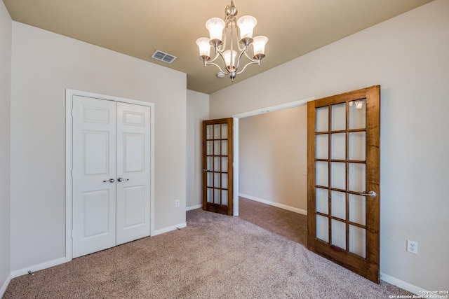 10603 Catfish Ln, San Antonio, TX 78224 - unfurnished bedroom with carpet floors, a chandelier, french doors, and baseboards
