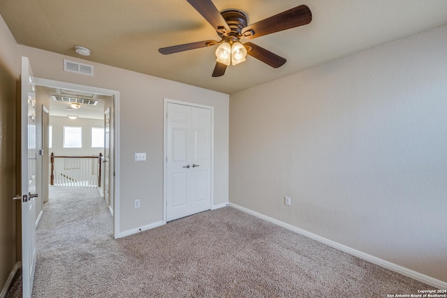 10603 Catfish Ln, San Antonio, TX 78224 - unfurnished bedroom featuring carpet flooring, baseboards, attic access, and a ceiling fan