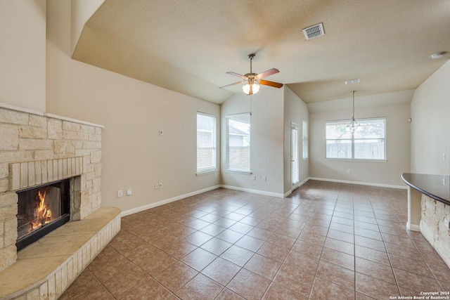 10603 Catfish Ln, San Antonio, TX 78224 - unfurnished living room featuring ceiling fan, lofted ceiling, a fireplace, tile patterned floors, and baseboards