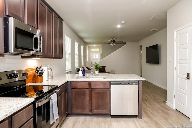 236/238 Joseph Cir, Cibolo, TX 78108 - kitchen with a ceiling fan, light wood finished floors, a sink, a peninsula, and stainless steel appliances