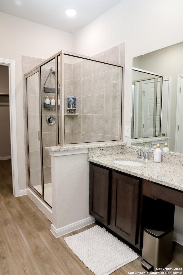 236/238 Joseph Cir, Cibolo, TX 78108 - full bathroom featuring vanity, baseboards, a shower stall, and wood finished floors