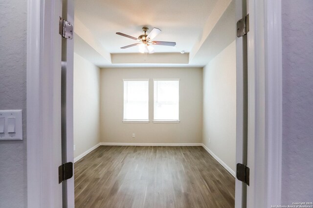 236/238 Joseph Cir, Cibolo, TX 78108 - spare room with ceiling fan, a raised ceiling, baseboards, and wood finished floors