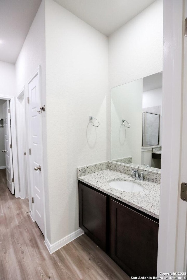 236/238 Joseph Cir, Cibolo, TX 78108 - bathroom with vanity, wood finished floors, and baseboards