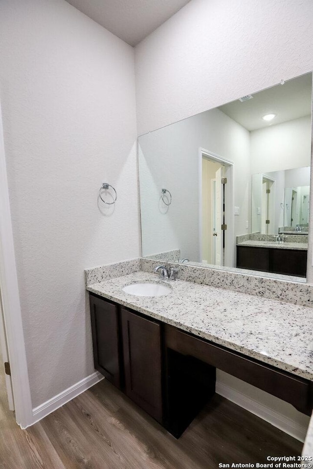 236/238 Joseph Cir, Cibolo, TX 78108 - bathroom featuring baseboards, vanity, and wood finished floors