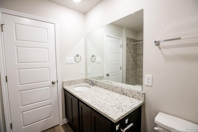 236/238 Joseph Cir, Cibolo, TX 78108 - bathroom with walk in shower, toilet, wood finished floors, and vanity