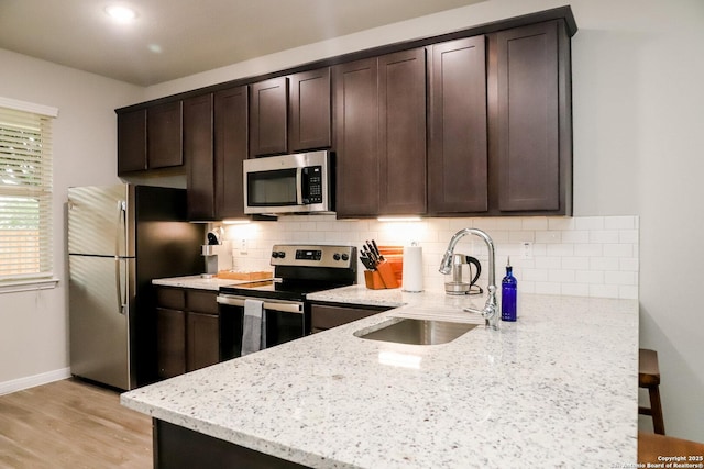 236/238 Joseph Cir, Cibolo, TX 78108 - kitchen with a sink, stainless steel appliances, dark brown cabinetry, light stone countertops, and tasteful backsplash