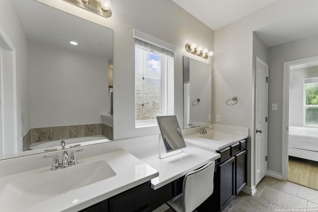 14626 Costa Leon, San Antonio, TX 78245 - bathroom featuring connected bathroom, baseboards, vanity, and a tub to relax in