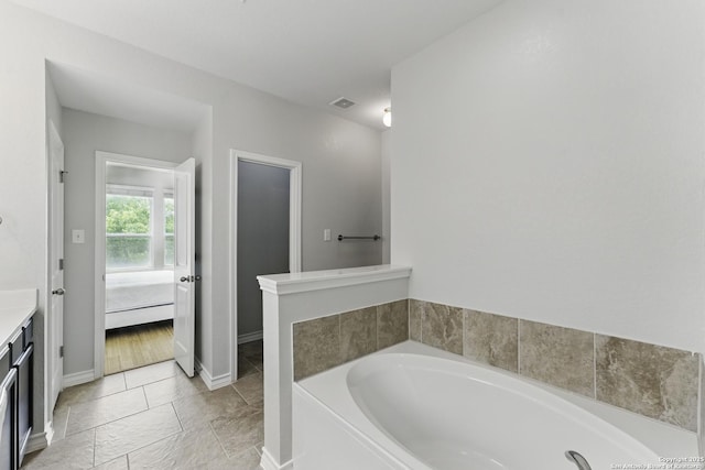 14626 Costa Leon, San Antonio, TX 78245 - bathroom featuring baseboards, visible vents, a bath, vanity, and connected bathroom