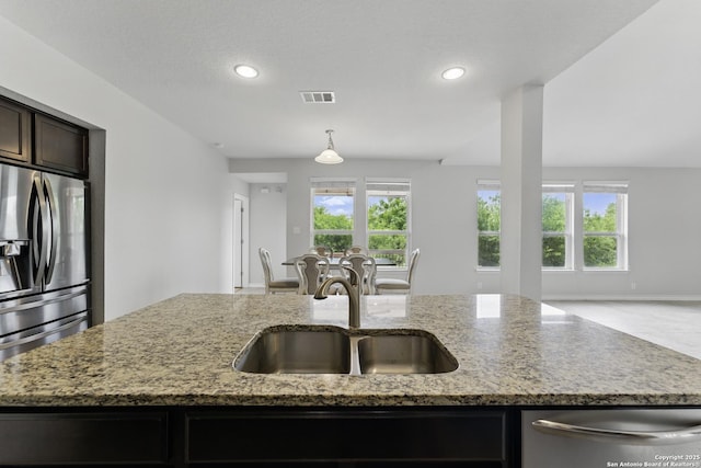 14626 Costa Leon, San Antonio, TX 78245 - kitchen with a sink, open floor plan, visible vents, appliances with stainless steel finishes, and light stone counters