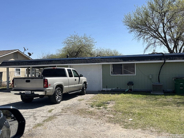 5738 Harefield, San Antonio, TX 78228 - view of side of property featuring a yard, driveway, central air condition unit, and an attached garage